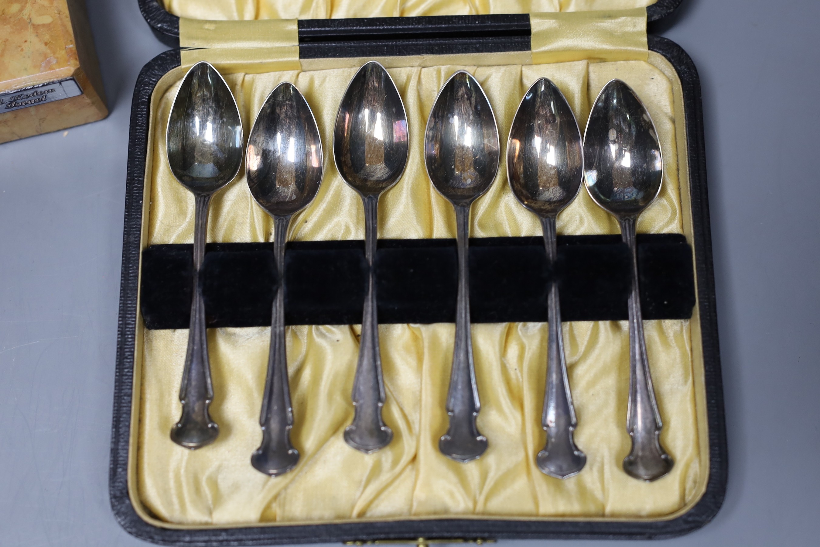A 925 standard model of a violinist by A. Kedem of Israel, on marble plinth, 18cm, and a cased set of six silver coffee spoons